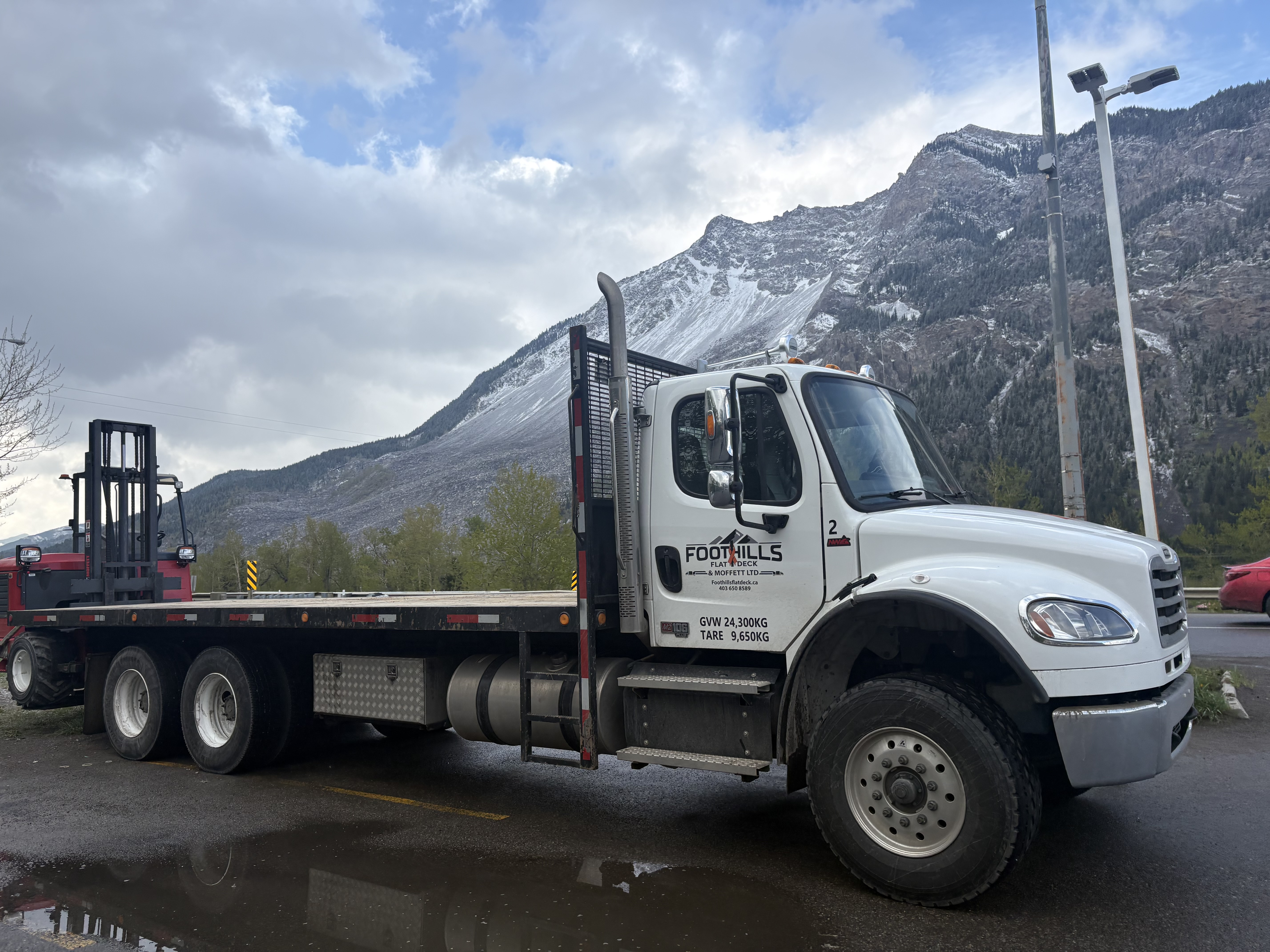 Foothills Flat Deck truck with Moffett — Alberta mountains